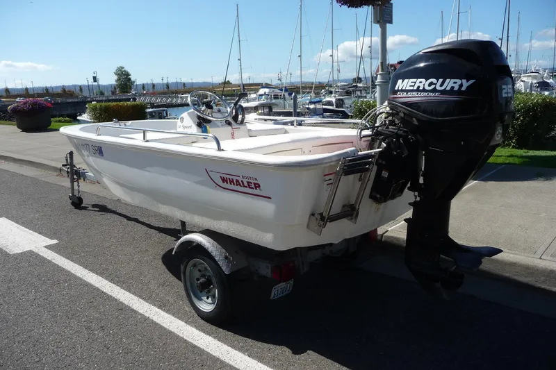 Slide: The Image of 2018 Boston Whaler 110 Sport boat with Mercury engine on trailer by marina. - 7