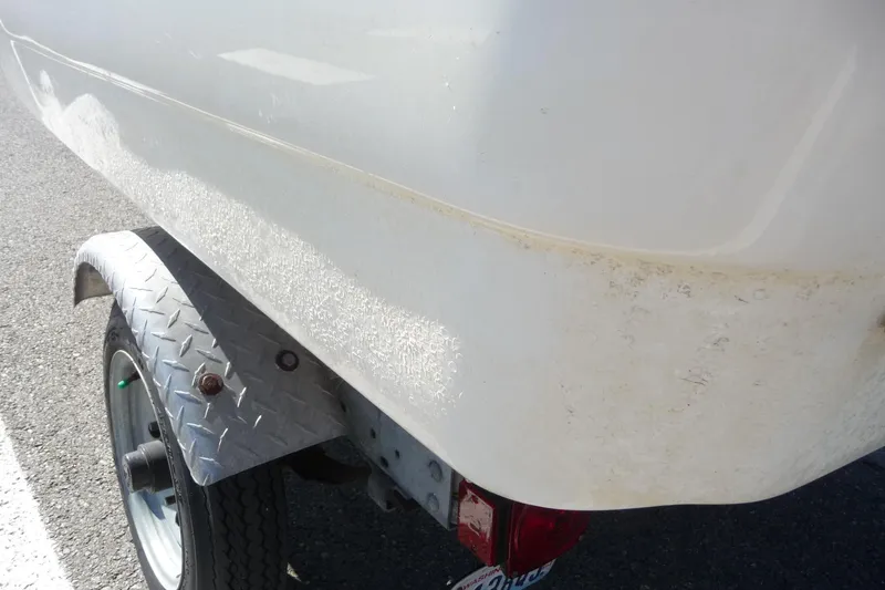 Slide: The Image of 2018 Boston Whaler 110 Sport boat on trailer, showing hull and wheel detail. - 8