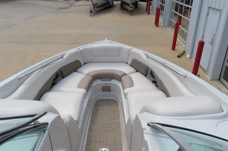 Slide: The Image of 2019 C 285ss boat with spacious white and beige seating, docked near a building. - 14