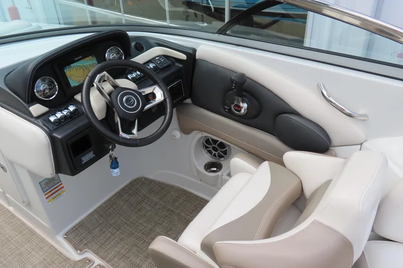 Slide: The Image of 2019 C 285ss boat interior with steering wheel, dashboard, and beige seating. - 19
