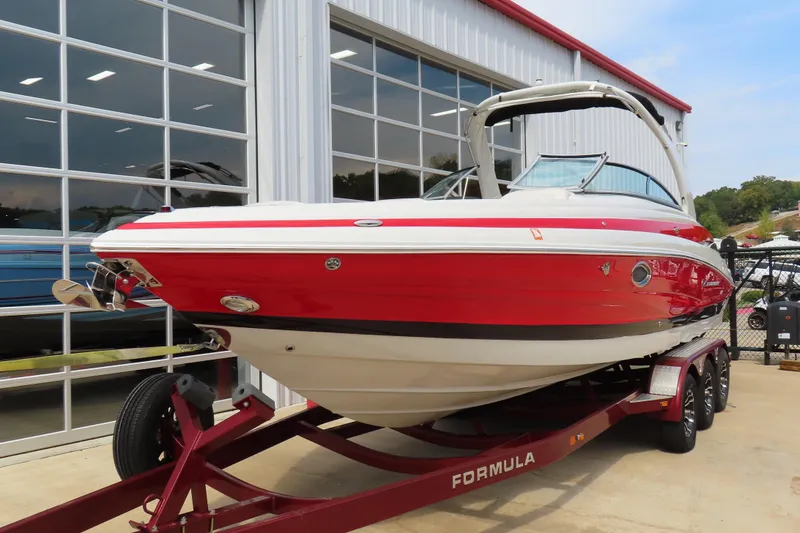 Slide: The Image of 2019 C 285ss boat in vibrant red on a trailer outside a showroom. - 2