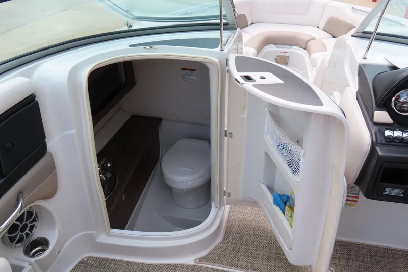 Slide: The Image of 2019 C 285ss boat interior with open bathroom door, showcasing toilet and seating area. - 21