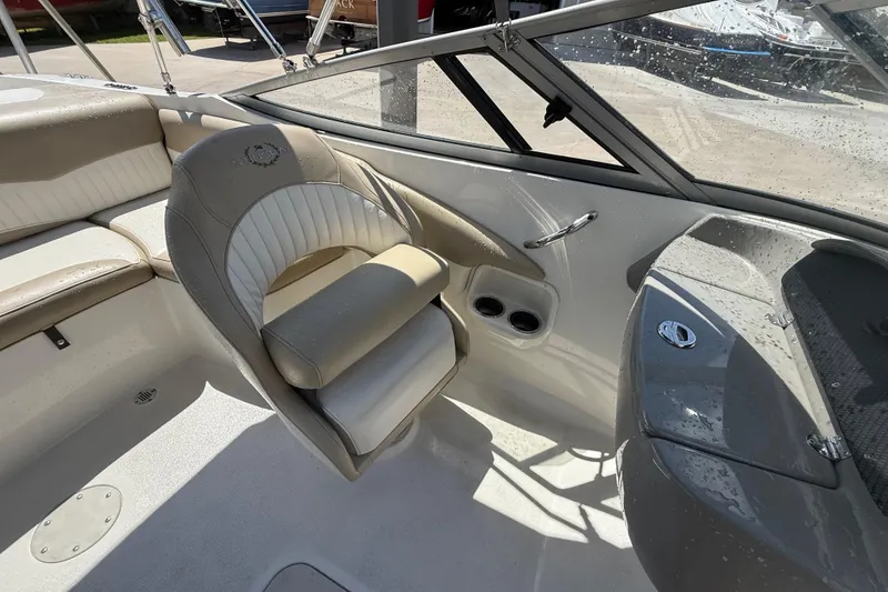 Slide: The Image of 2017 Stingray 204 LR boat interior with beige seating and dashboard details. - 10