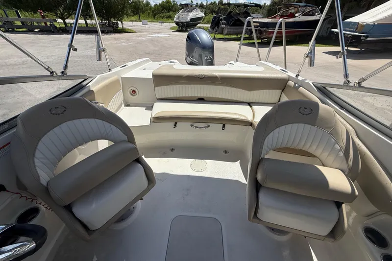 Slide: The Image of 2017 Stingray 204 LR boat interior with beige seating and steering wheel. - 11