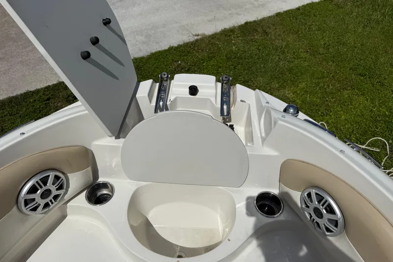 Slide: The Image of 2017 Stingray 204 LR boat interior with speakers and cup holders. - 13