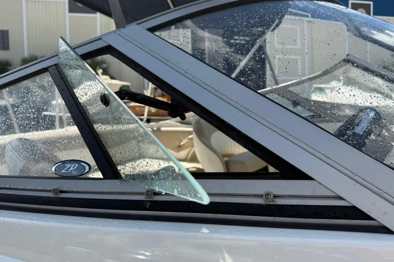 Slide: The Image of Close-up of 2017 Stingray 204 LR boat windshield with water droplets. - 16