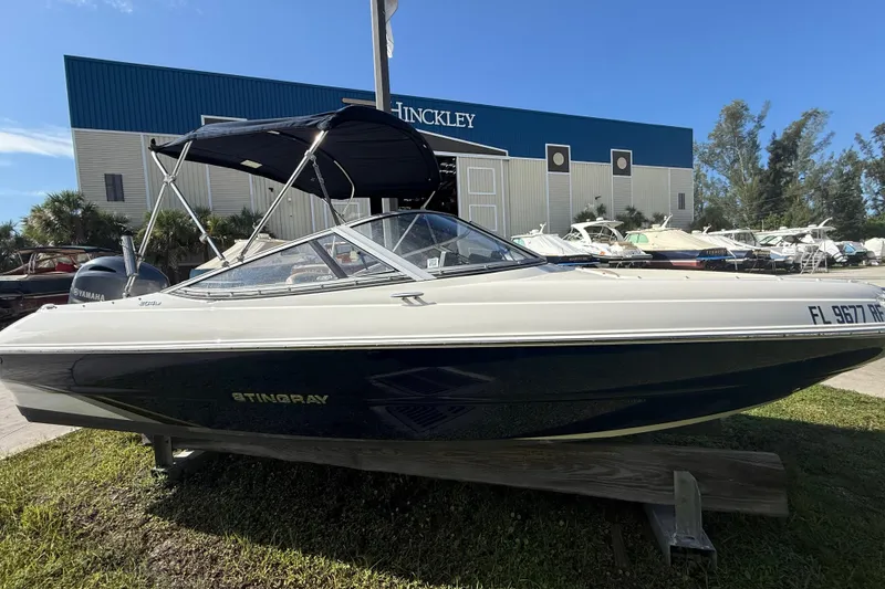 Slide: The Image of 2017 Stingray 204 LR boat displayed outdoors near Hinckley building. - 23
