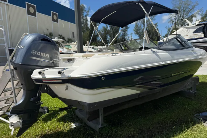 Slide: The Image of 2017 Stingray 204 LR boat with Yamaha 115 engine, docked outdoors. - 24
