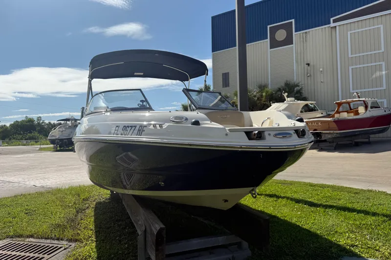 Slide: The Image of 2017 Stingray 204 LR boat on display outdoors, with a blue and white exterior. - 25