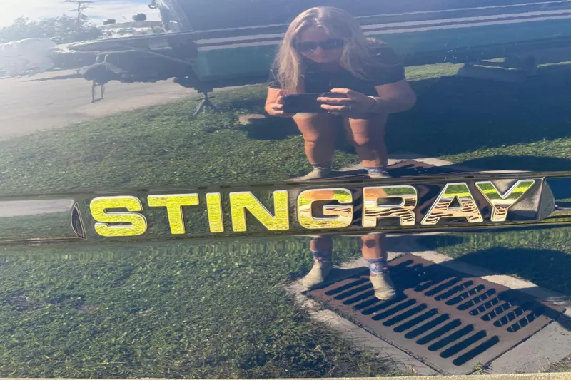 Slide: The Image of Reflection on 2017 Stingray 204 LR boat with person taking a photo. - 27