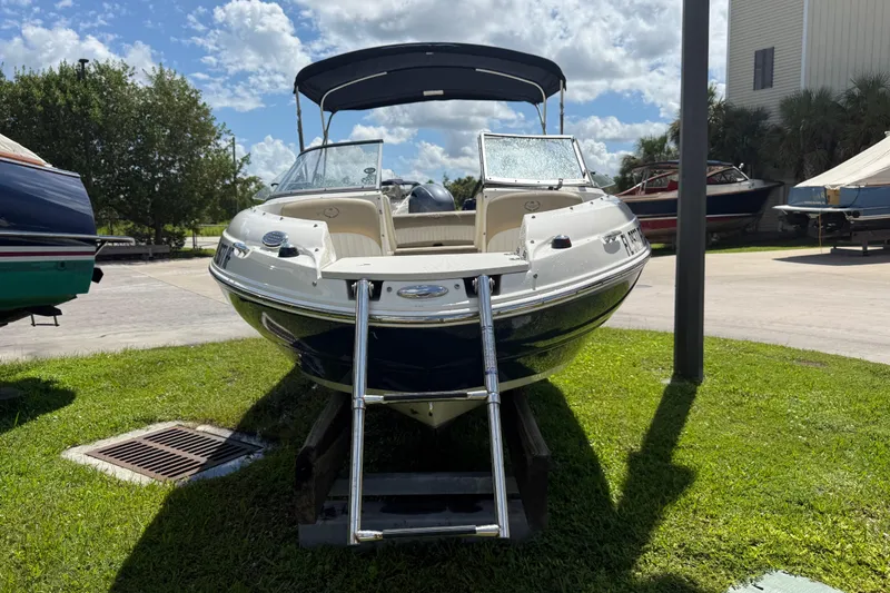 Slide: The Image of 2017 Stingray 204 LR boat on grass with ladder, under a sunny sky. - 3