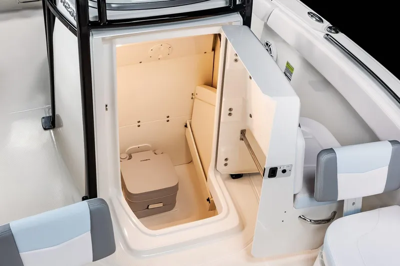 Slide: The Image of Manufacturer Provided Image: 2025 Robalo R232 Explorer boat interior with compact cabin and portable toilet. - 7