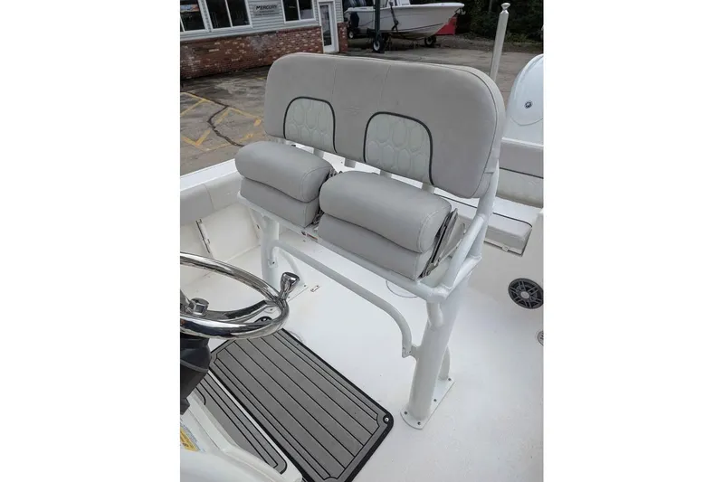 Slide: The Image of 2024 Sea Fox 228 Commander boat interior with cushioned seating and steering wheel. - 10