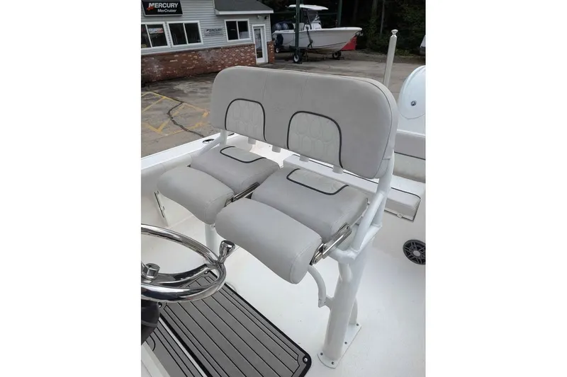 Slide: The Image of 2024 Sea Fox 228 Commander boat seating with gray upholstery and steering wheel. - 11