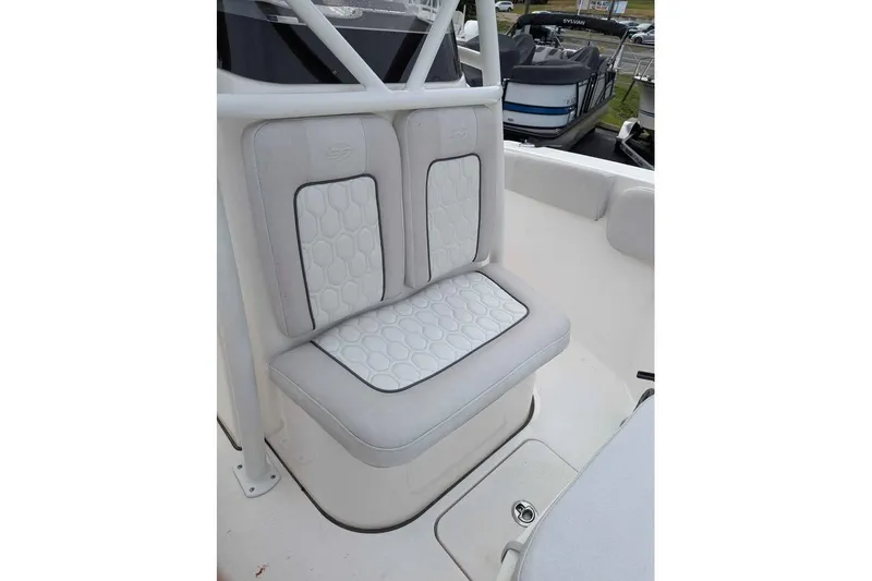 Slide: The Image of 2024 Sea Fox 228 Commander boat seat with white cushioned upholstery and hexagonal pattern. - 13