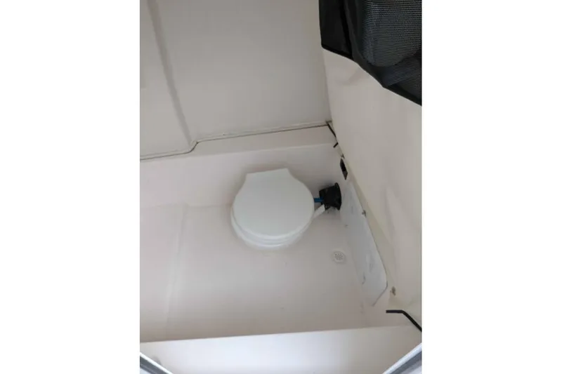 Slide: The Image of 2024 Sea Fox 228 Commander boat interior with compact marine toilet. - 14