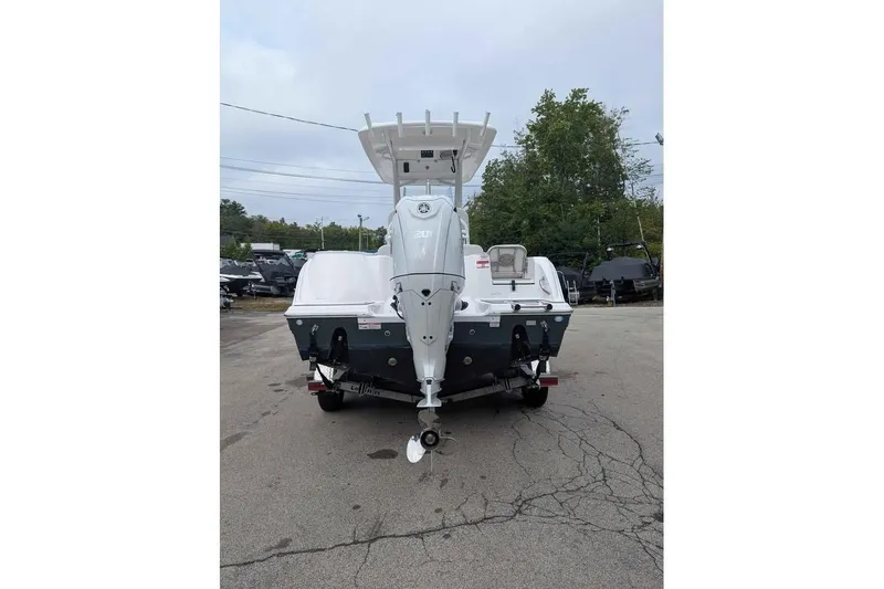 Slide: The Image of 2024 Sea Fox 228 Commander boat, rear view with outboard motor, parked on a trailer. - 3