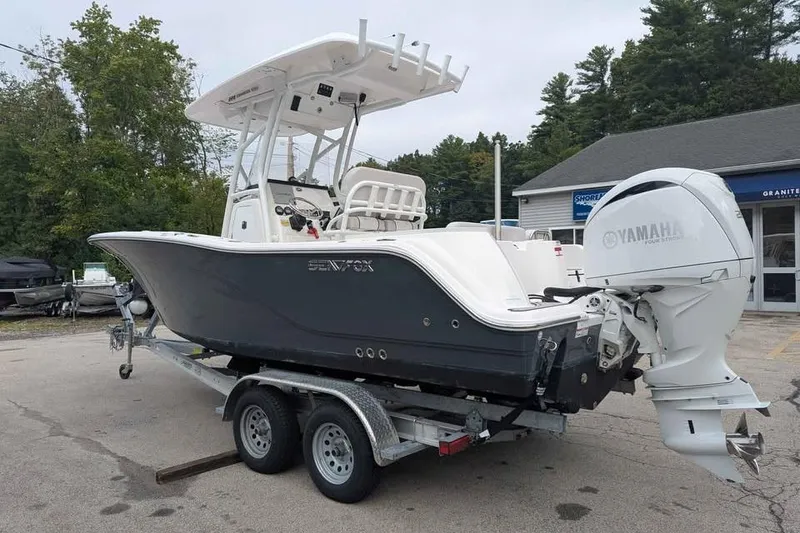 Slide: The Image of 2024 Sea Fox 228 Commander boat on trailer with Yamaha engine, parked outdoors. - 4