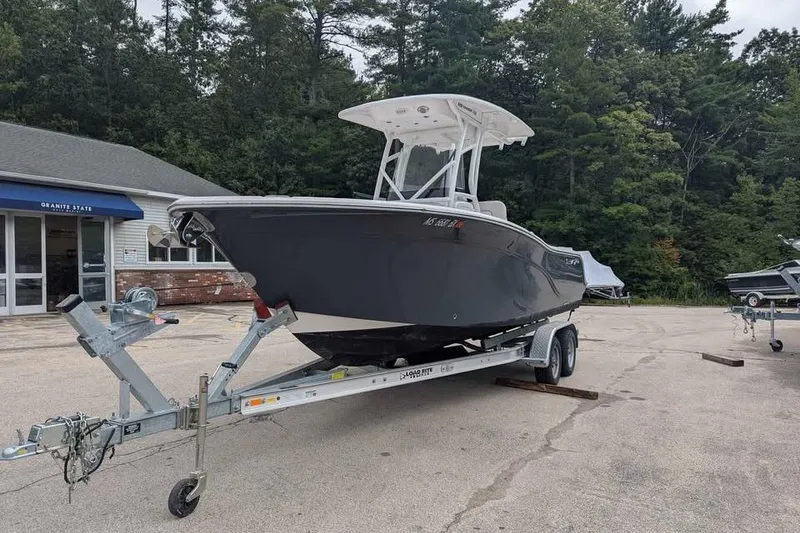 Slide: The Image of 2024 Sea Fox 228 Commander boat on trailer, parked outdoors near a building. - 5