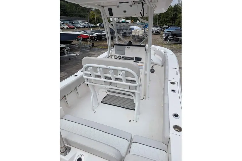 Slide: The Image of 2024 Sea Fox 228 Commander boat interior with seating and console, docked outdoors. - 6