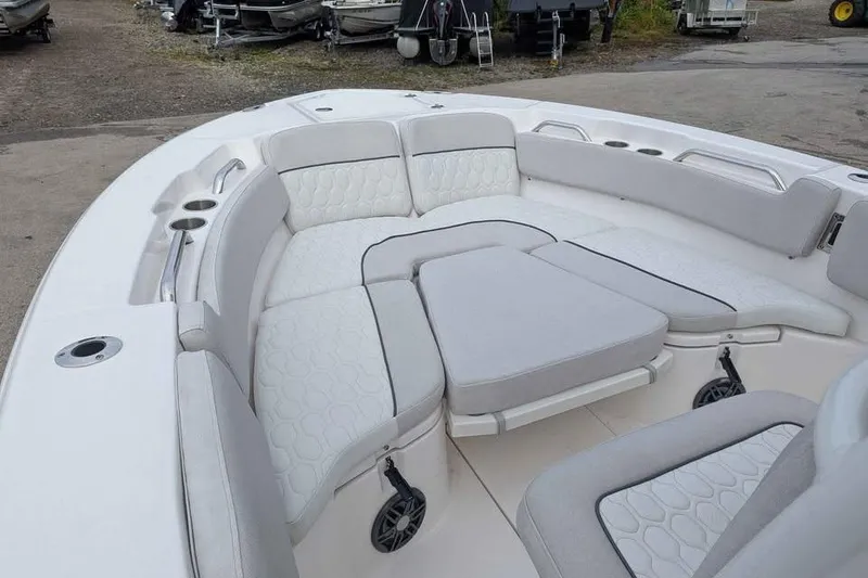 Slide: The Image of 2024 Sea Fox 228 Commander boat with spacious, cushioned seating area and cup holders. - 9