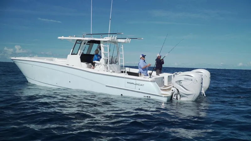 Slide: The Image of 2026 World Cat 400CC-X boat on open sea with people fishing. - 10