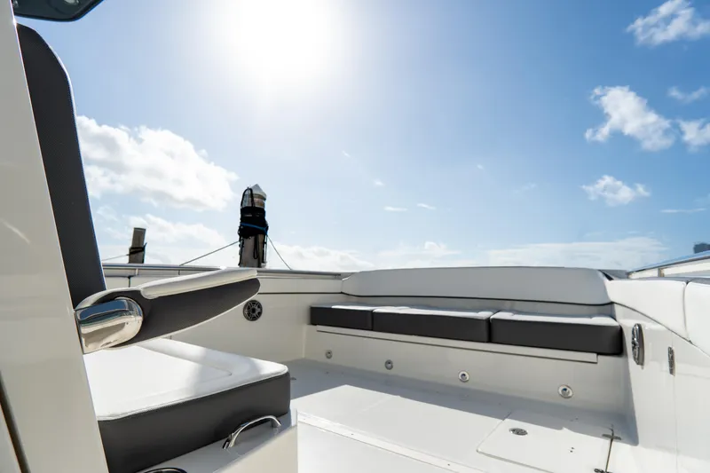 Slide: The Image of 2026 World Cat 400CC-X boat interior with seating under bright sun and blue sky. - 17