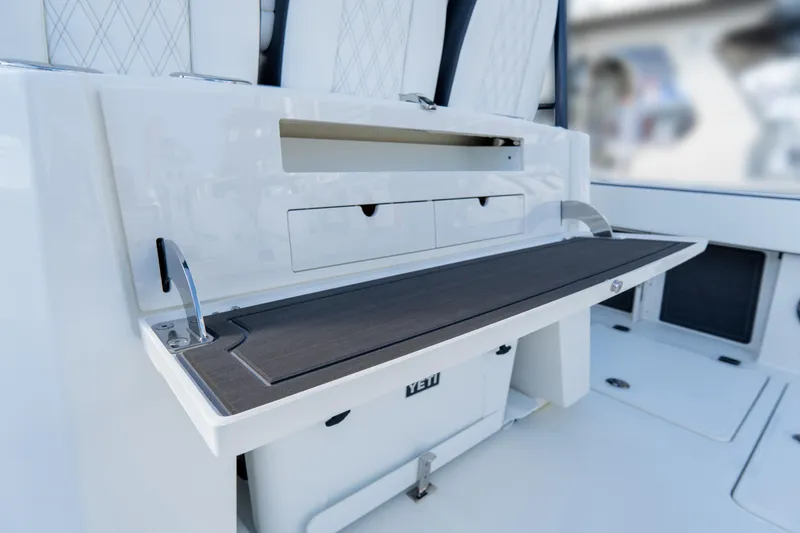 Slide: The Image of 2026 World Cat 400CC-X boat interior with storage compartments and seating. - 19
