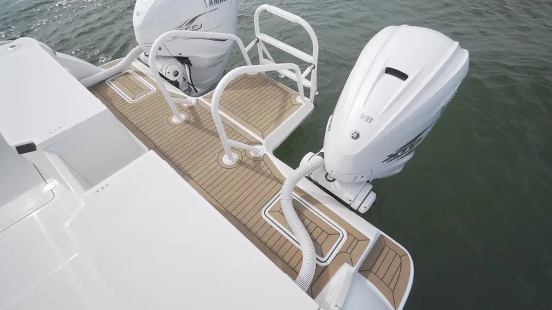 Slide: The Image of 2026 World Cat 400CC-X boat with twin outboard engines on teak deck. - 21