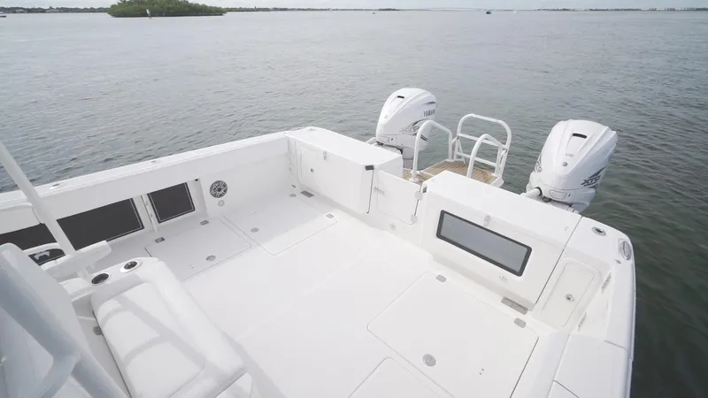 Slide: The Image of 2026 World Cat 400CC-X boat deck with dual engines on calm water. - 24