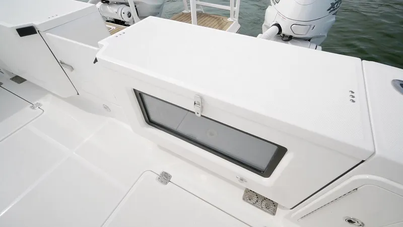 Slide: The Image of 2026 World Cat 400CC-X boat deck with storage compartment and outboard motors. - 25