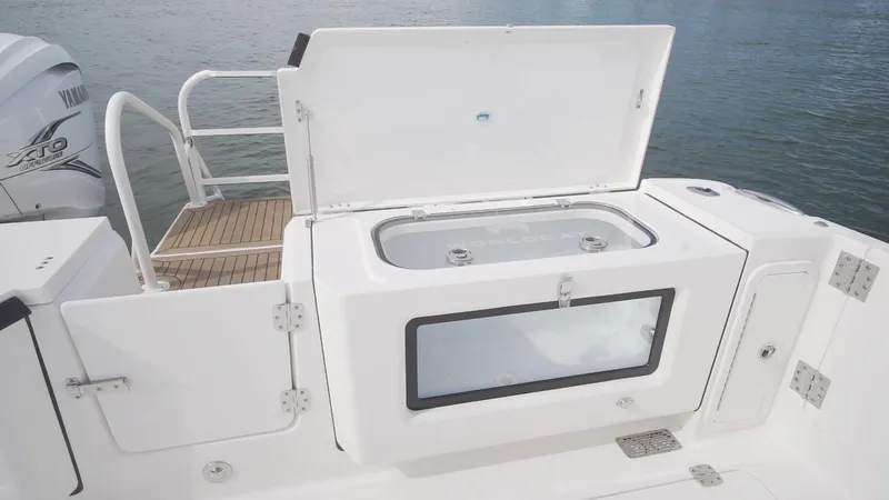 Slide: The Image of 2026 World Cat 400CC-X boat with open storage compartment on deck. - 28
