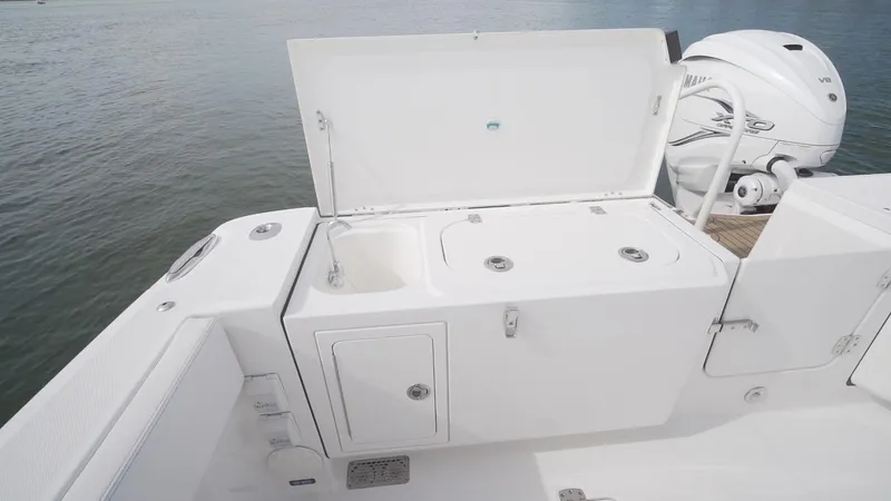 Slide: The Image of 2026 World Cat 400CC-X boat with open storage compartment and outboard motor. - 29