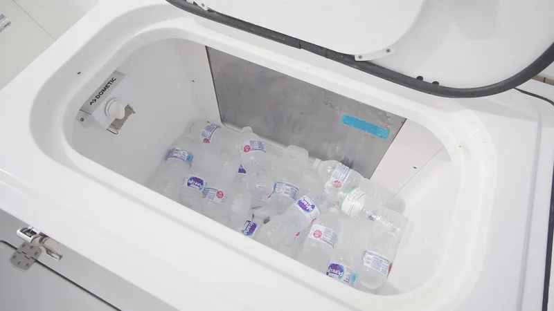 Slide: The Image of Cooler with bottled water inside a 2026 World Cat 400CC-X boat. - 30