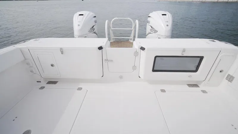 Slide: The Image of 2026 World Cat 400CC-X boat deck with twin engines, spacious layout, and storage compartments. - 33