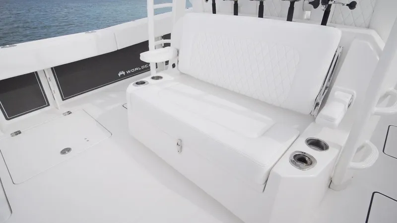 Slide: The Image of 2026 World Cat 400CC-X boat interior with white seating and cup holders. - 34