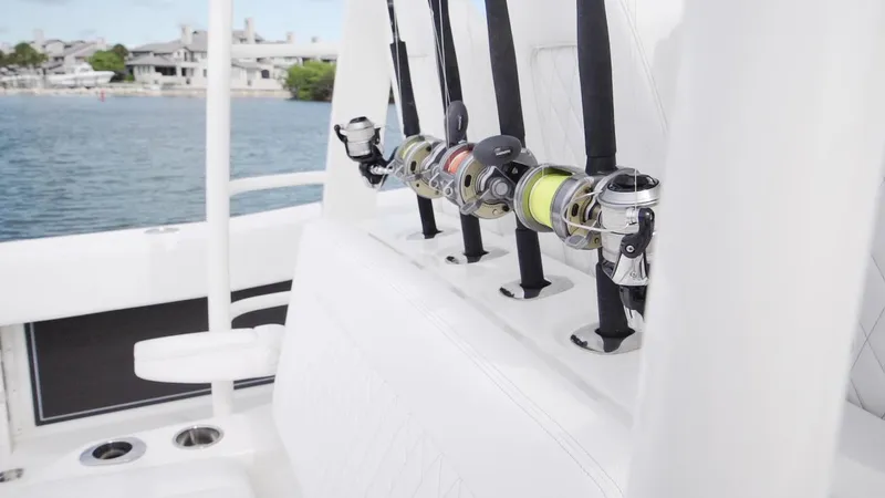 Slide: The Image of Fishing rods on a 2026 World Cat 400CC-X boat, docked by the water. - 36