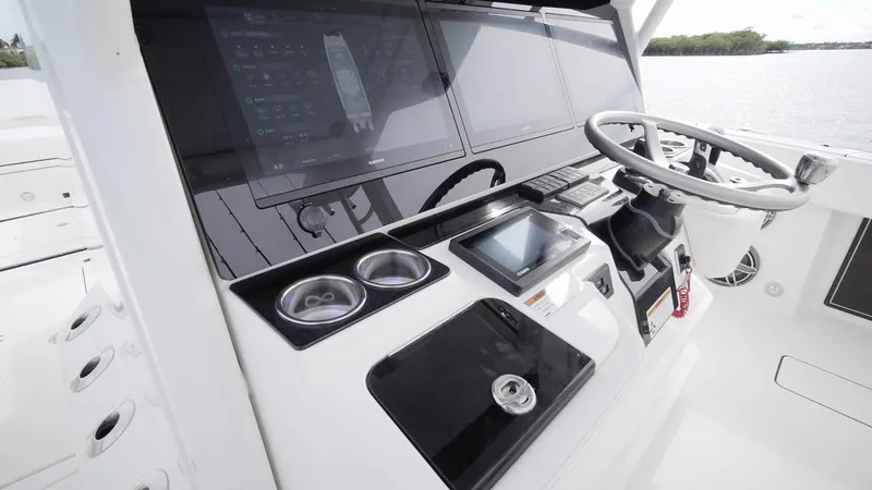 Slide: The Image of 2026 World Cat 400CC-X boat dashboard with modern controls and steering wheel. - 37