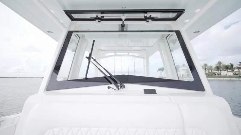 Slide: The Image of 2026 World Cat 400CC-X boat windshield with wiper, showcasing sleek design and waterfront view. - 43