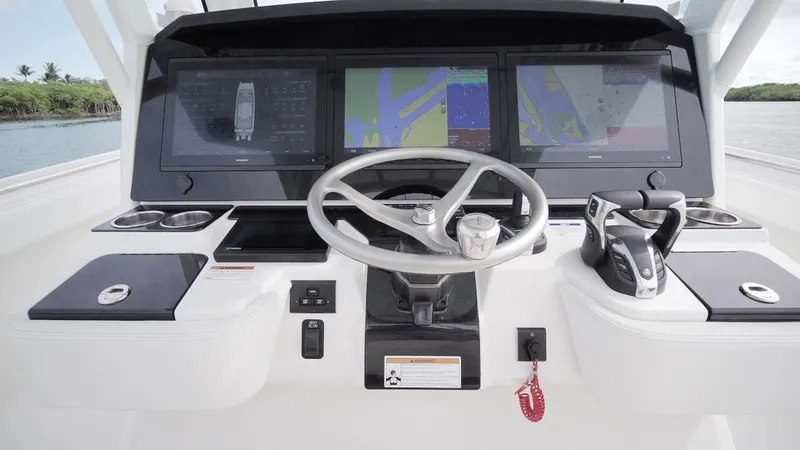 Slide: The Image of Helm of 2026 World Cat 400CC-X boat with advanced navigation displays and controls. - 44
