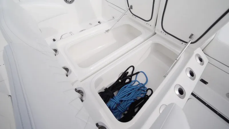 Slide: The Image of 2026 World Cat 400CC-X boat storage compartments with blue rope and accessories. - 49