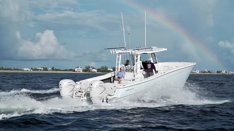 Slide: The Image of 2026 World Cat 400CC-X boat cruising on water with a rainbow in the background. - 9