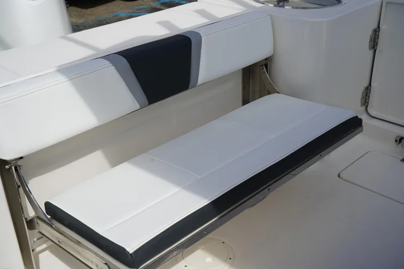 Slide: The Image of 2026 Robalo R250 Center Console boat seat, white and navy design. - 10