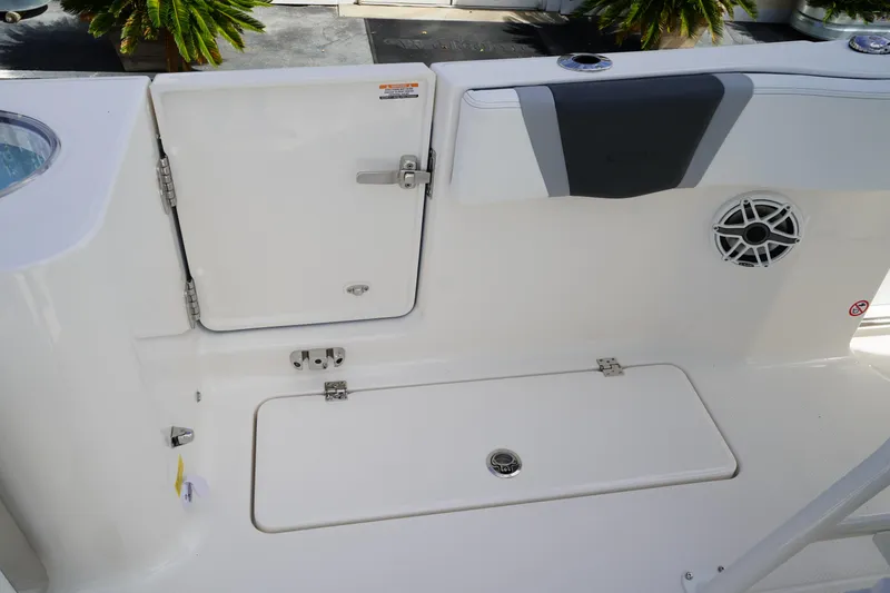 Slide: The Image of 2026 Robalo R250 Center Console boat deck with storage compartments and speaker. - 12