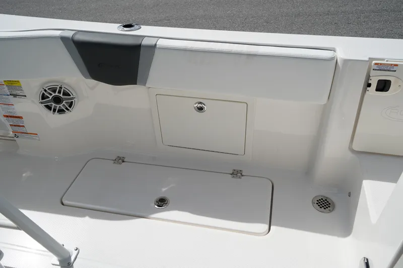 Slide: The Image of 2026 Robalo R250 Center Console boat interior with storage compartments and speaker. - 13