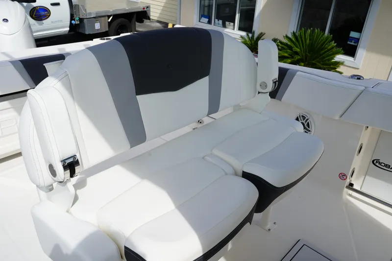 Slide: The Image of 2026 Robalo R250 Center Console boat seat, white and gray upholstery, outdoor setting. - 20