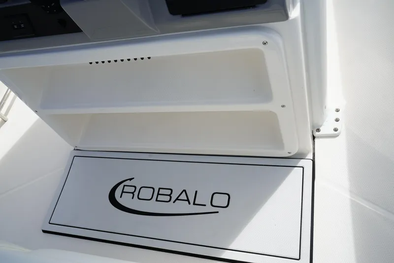 Slide: The Image of 2026 Robalo R250 Center Console boat interior detail with logo. - 22