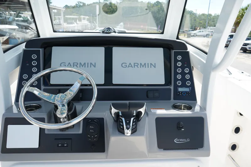 Slide: The Image of 2026 Robalo R250 Center Console dashboard with dual Garmin displays and steering wheel. - 23