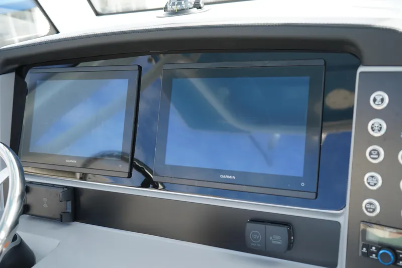 Slide: The Image of 2026 Robalo R250 Center Console dashboard with dual Garmin displays and control panel. - 24