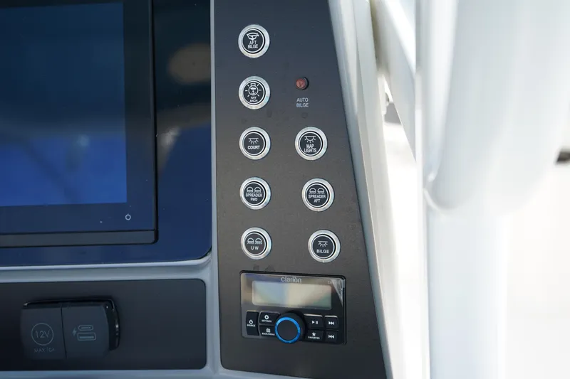 Slide: The Image of Control panel of 2026 Robalo R250 Center Console boat with various switches and display. - 25